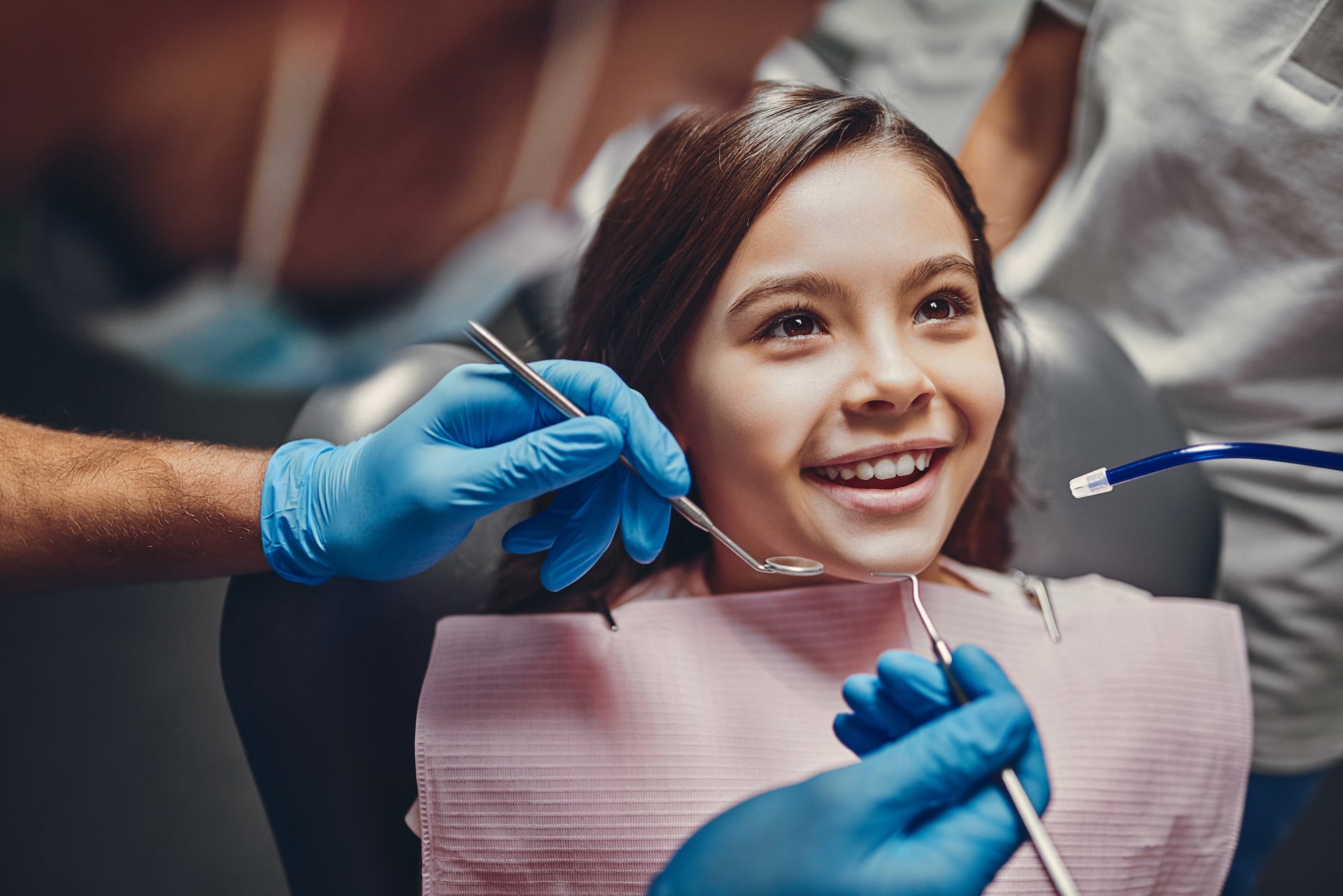 dentista che mette apparecchio dentale a una bambina